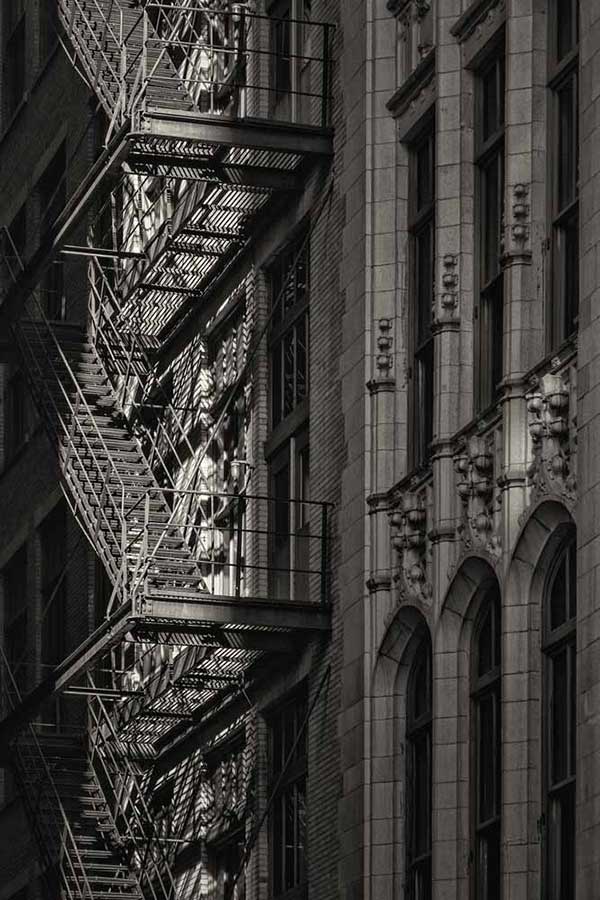 Metal fire escape stairs hanging on side of old Chicago building © Ron Fross - Route 66