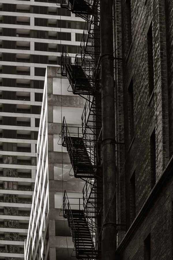 Metal fire escape stairs hanging on side of old Chicago building © Ron Frossard - Route 66